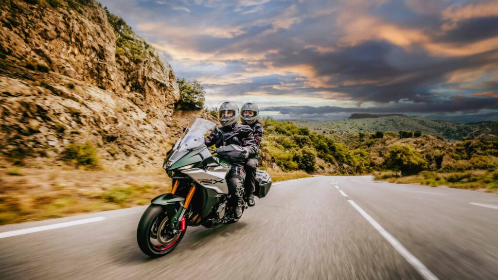 Motorcycle rider and pillion on road trip
